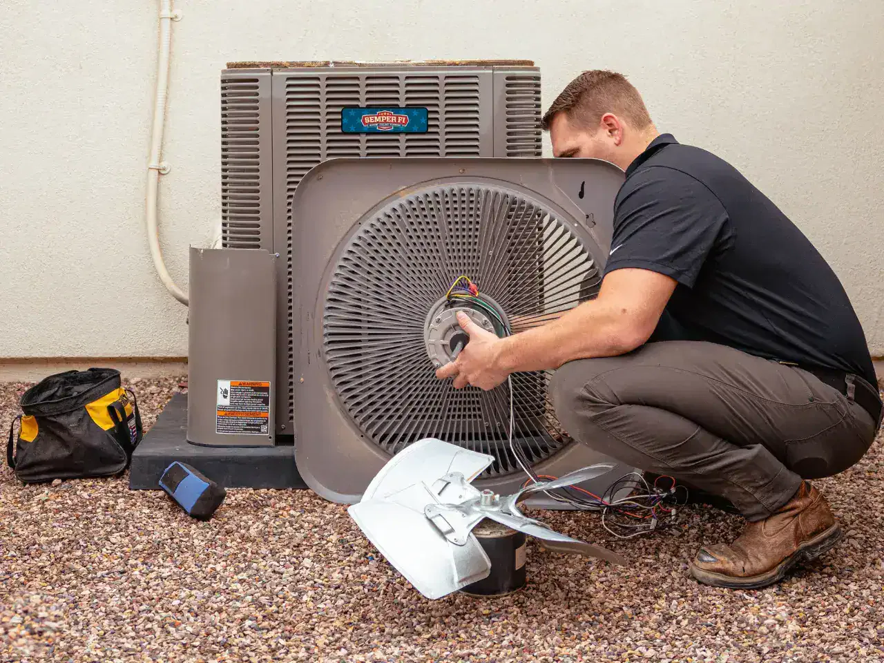 HVAC technician performing AC maintenance and repair on residential air conditioning system